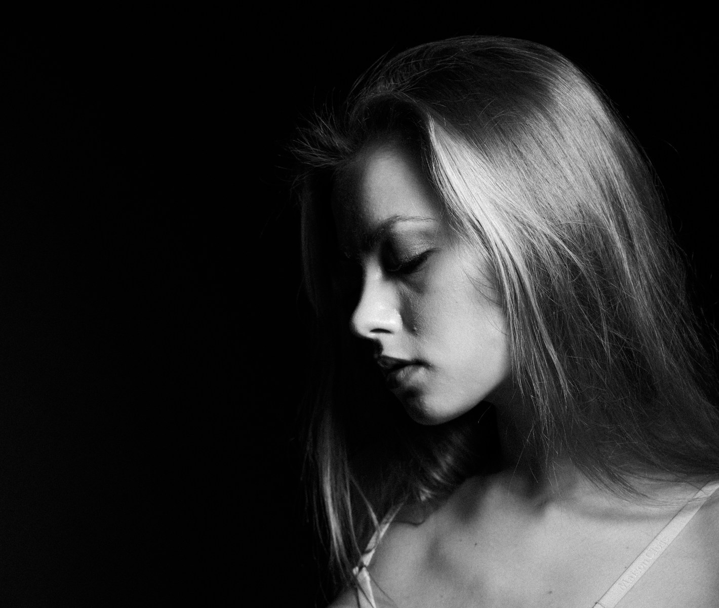 a black and white photo of a woman with long hair