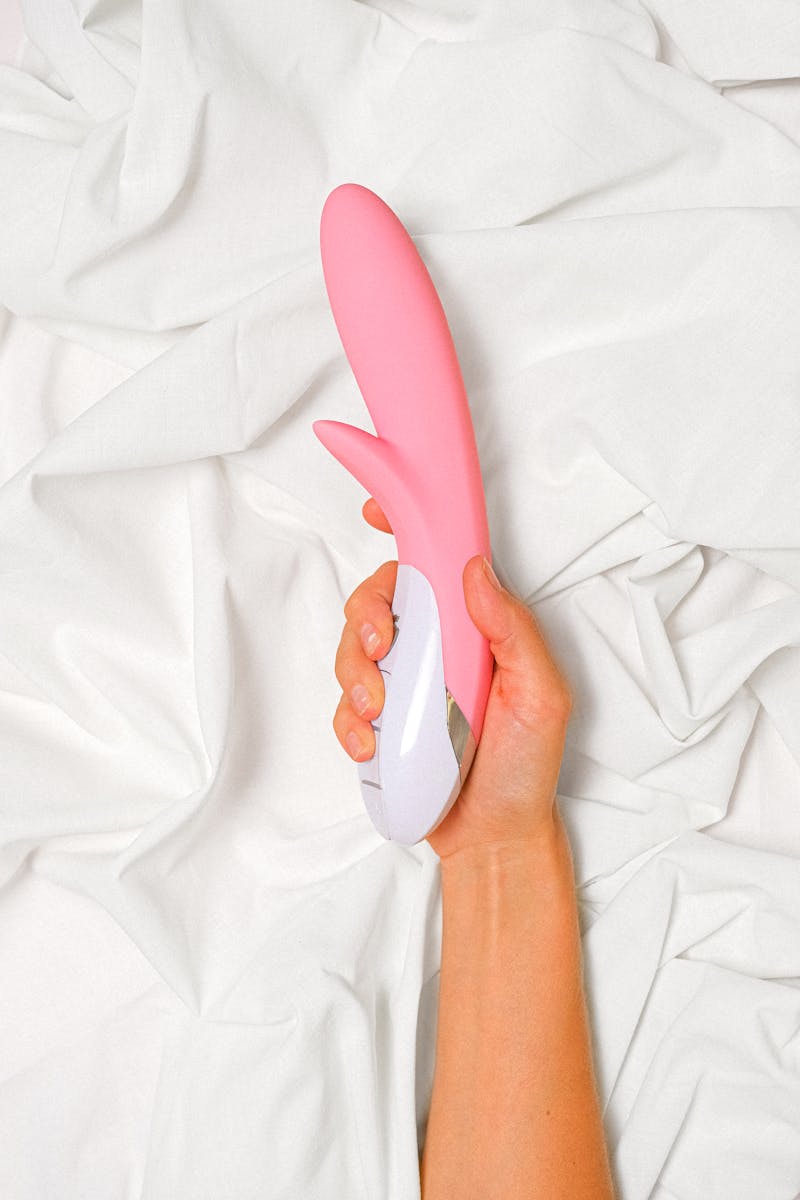 Person Holding a Pink Vibrator